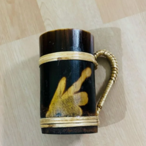 Handmade bamboo mug with traditional art and wrapped handle